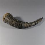 A RITUAL RATTLE: Tibet, 19th century yak horn, with hide cover at the open end, carved with ritual
