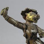 A BRONZE FIGURE OF VARAHI: Tibet, 18th century The boar headed goddess dancing with her right hand