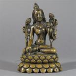 A BRONZE FIGURE OF WHITE TARA: Tibet, late 17th/early 18th century seated on a double lotus throne,