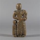 A FRAGMENTARY WOOD CARVING, Nepal, circa 18th century Depicting Mayadevi and Buddha (?), the mother