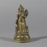 A BRONZE FIGURE OF PADMAPANI, Tibet, 17th/18th century standing on a lotus, wearing voluminous