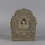 A COPPER AND SILVER ALLOY GAU, Tibet, 18th century Of lobed arched form, the front panel profusely