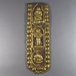A COPPER GILT REPOUSSE RELIEF PANEL, Tibet, 18th century Of fragmentary cartouche-shaped form,