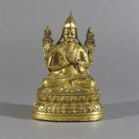 A GILT BRONZE FIGURE OF TSONG KA PA, Tibet, 18th/19th century seated on a double lotus throne, his
