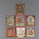 SEVEN SMALL TSAKLIS, Tibet, 18th-19th century pigment with gold on cloth, one depicting Tsong Ka