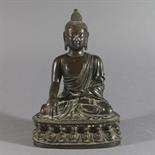 A BRONZE FIGURE OF SAKYAMUNI BUDDHA, China, circa 17th century Seated in dhyana sauna on a double