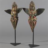 TWO POLYCHROME-PAINTED WOOD RITUAL DAGGERS (phur-bu), Tibet, 19th century Each depicting a figure