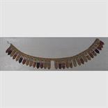 A TEMPLE HANGING, Tibet, 19th century composed of a row of thirty tsaklis mounted on cloth, each