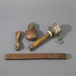 FOUR TIBETAN OBJECTS, Circa 19th century Comprising a silver and wood prayer wheel, a brass and
