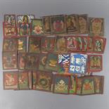 A COLLECTION OF TSAKLIS, Tibet, 20th century pigment on cloth and card, depicting Buddhist deities