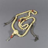 A BUDDHIST ROSARY (mala), Eastern Tibet, 19th century strung with 108 spherical ivory beads,