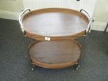 1970`s oval two tier trolley on wheels with simulated wood shelves,