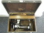 Singer sewing machine with gilt highlights, in original simulated skin carrying case