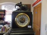 Decorative contemporary small mantle clock 8 day timepiece with small metal figure to the top of