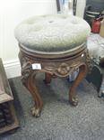 Late Victorian walnut wind up piano stool with button backed seating area on tripod scrolling