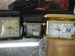 Crocodile skinned travelling clock by Agme, and 2 x 1950`s travelling clocks