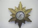 Gilt Sunburst wall clock with an 8 day timepiece, 6" dial makers name to dial Elliot est 20-50