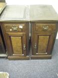 Pair of handed walnut bedside cupboards, each with a single door and drawer on a plinth base,