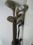 7 assorted old golf clubs with wooden handles, and original carrying case, well used condition