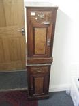 Pair of handed walnut bedside cupboards, each with a single door and drawer on a plinth base,