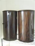 Pair of almost matching half moon shaped flame mahogany Victorian wall cabinets, each with a