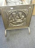 Brass fire screen with decoration to front in relief of a man and female in period dress c1900