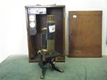 Antique mahogany cased microscope in original carrying case, assortment of brass lacquered lenses,