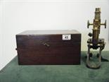 Victorian mahogany boxed Microscope with extra lenses, fold away action to the metal ware base with