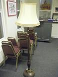 Mahogany standard lamp on circular base with fluted centre column and accompanying shade,