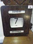 Perpetual calendar, c1950`s stained oak case with pro-turning knobs,