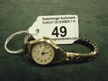 9ct gold Ladies 1950`s wrist watch on an elasticated strap, appears to be working