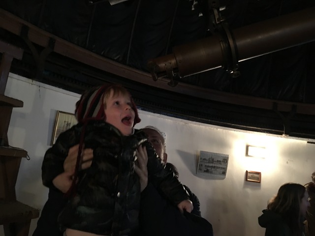 A young boy looking through the telescope at our real-working observatory