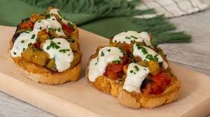 fried aubergines with cherry tomatoes and oil