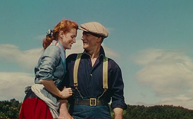 Maureen O'Hara whispers to John Wayne in The Quiet Man