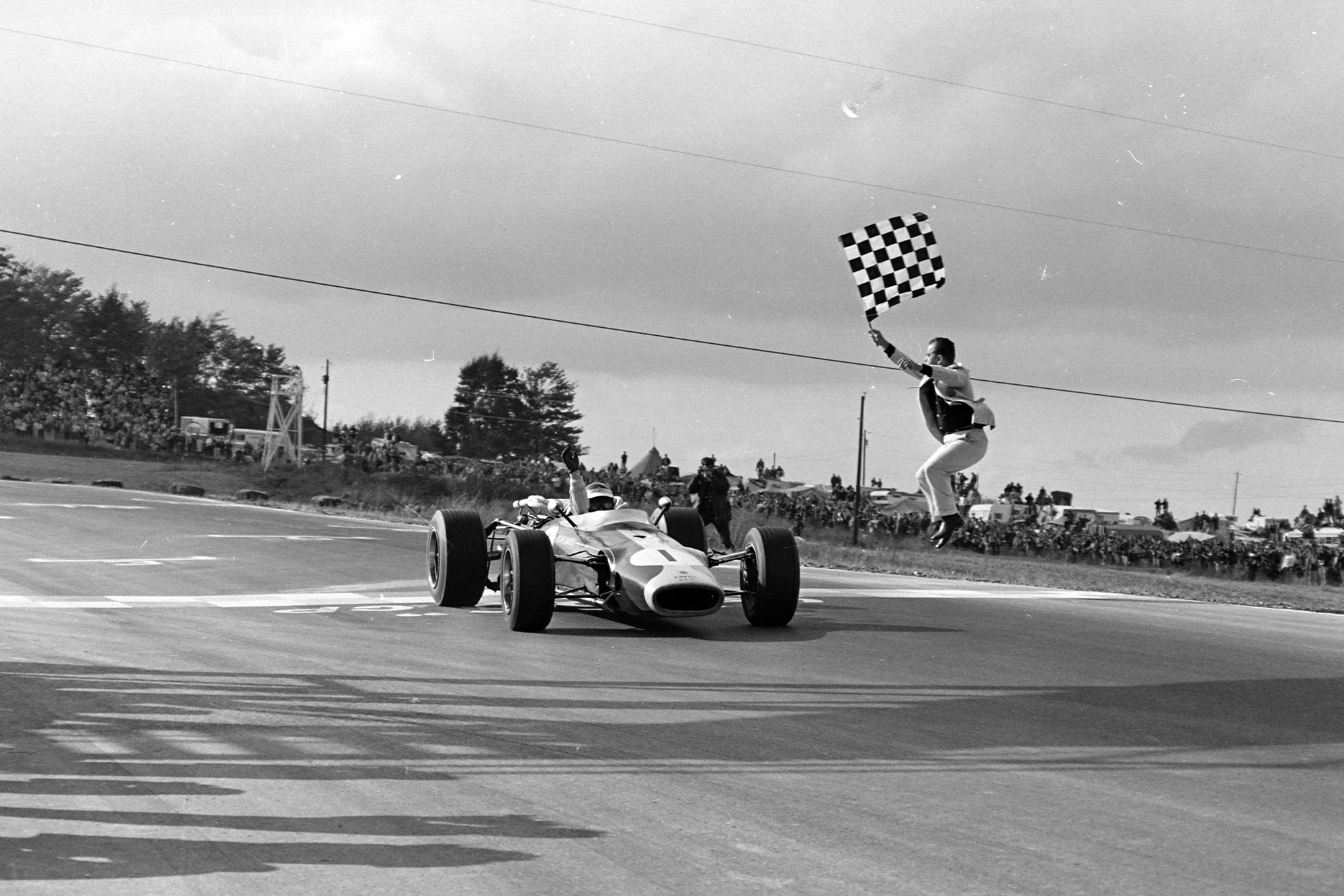 Jim Clark, Lotus 43 BRM takes the chequered flag for victory.