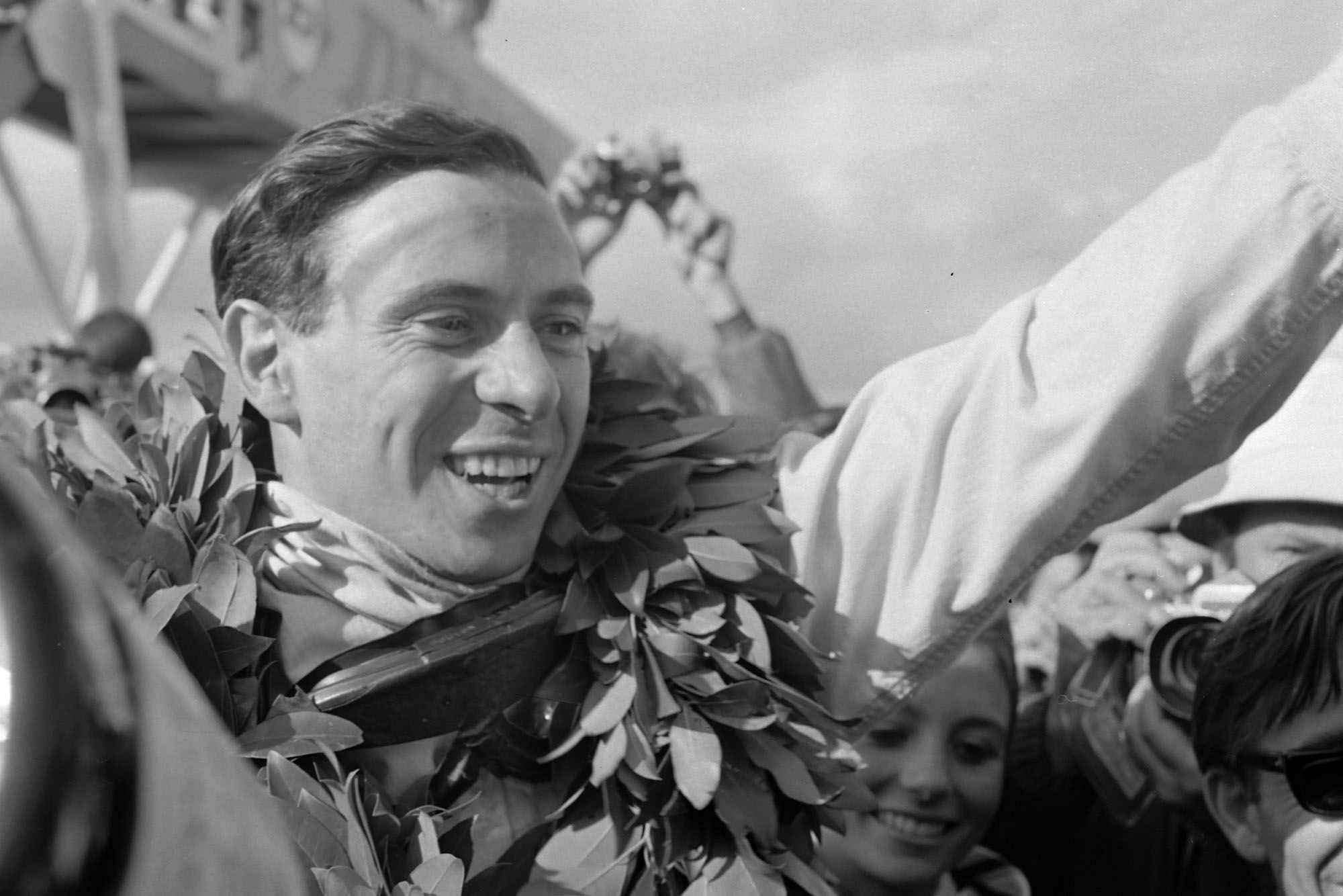 Race winner Jim Clark celebrates victory in the pit lane.