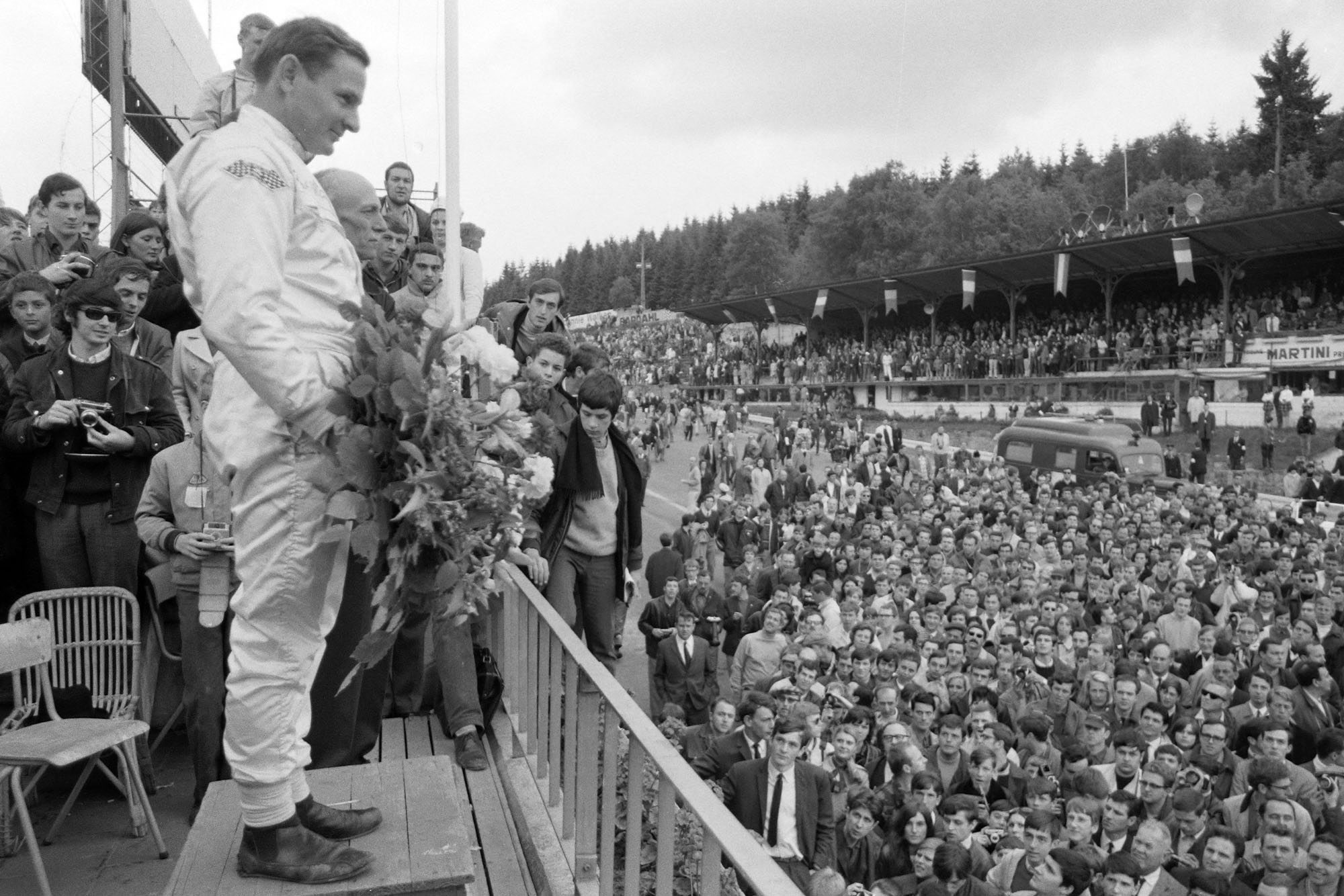 Bruce McLaren, 1st position, on the podium.