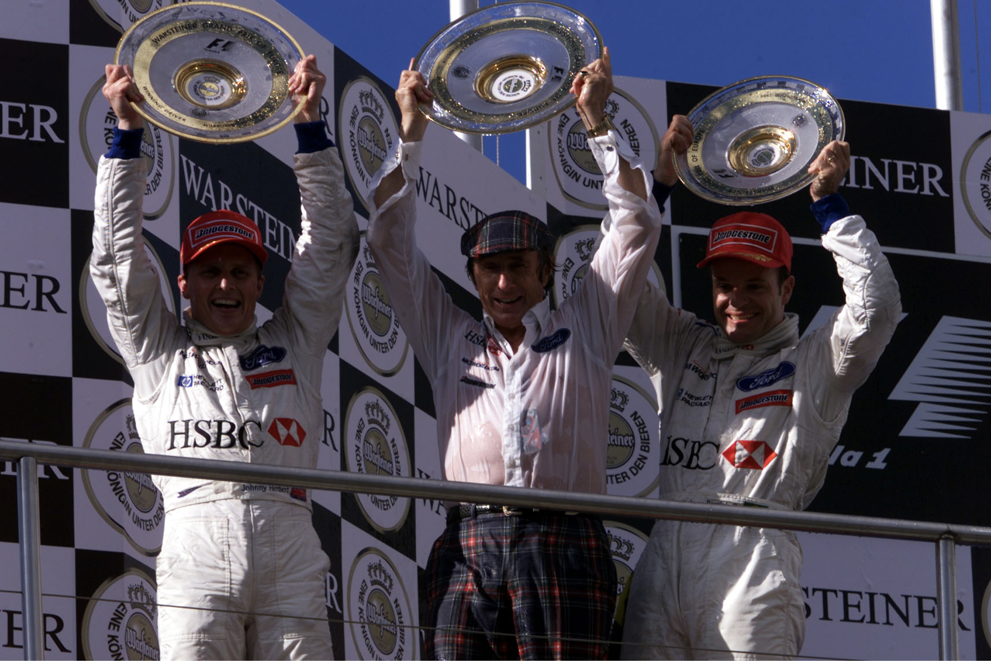 Johnny Herbert Jackie Stewart and Rubens BArrichello on the podium after the 1999 European Grand Prix at the Nurburgring