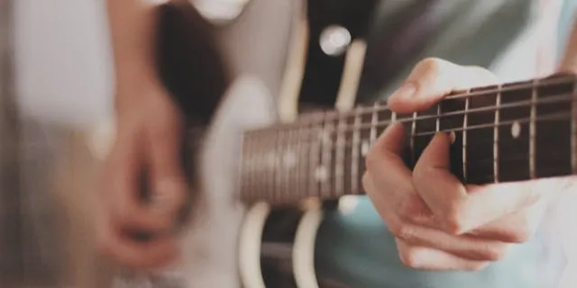 Man Learning the Minor and Major Pentatonic Scale on Guitar