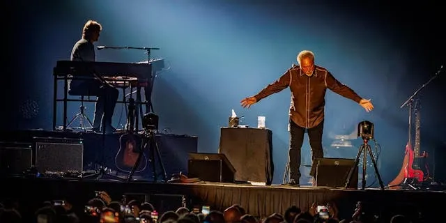 Paddy Milner on stage with Sir Tom Jones