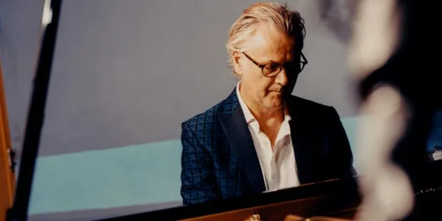 Guy Chambers playing the piano