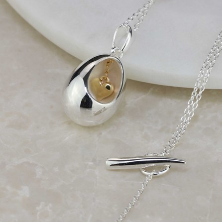 Oval Pendant With Miniature Hanging Heart Oval Pendant With Miniature Hanging Heart Silver