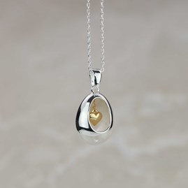 Oval Pendant With Miniature Hanging Heart Oval Pendant With Miniature Hanging Heart Silver