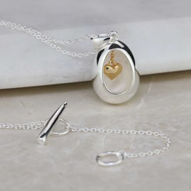 Oval Pendant With Miniature Hanging Heart Oval Pendant With Miniature Hanging Heart Silver