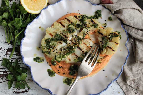 Cauliflower steaks with harissa hummus and chimichurri dressing