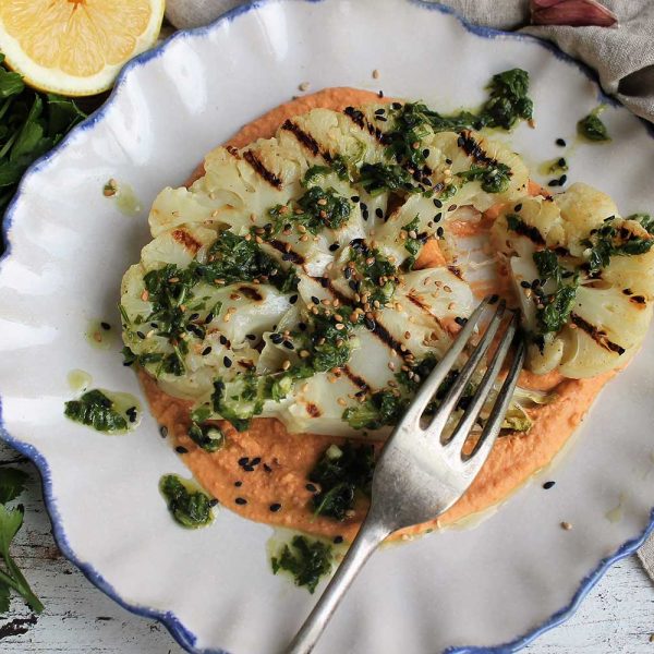 Cauliflower steaks with harissa hummus and chimichurri dressing