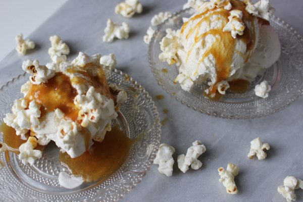 Homemade vanilla and agave ice cream with salted caramel sauce and popcorn