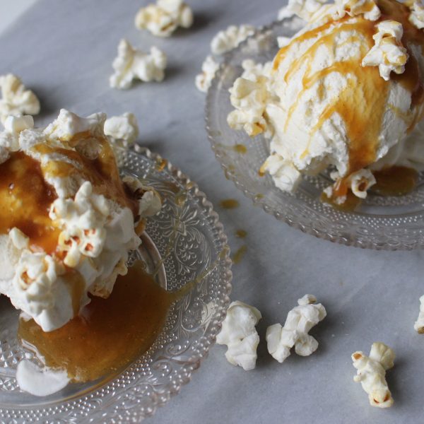 Homemade vanilla and agave ice cream with salted caramel sauce and popcorn