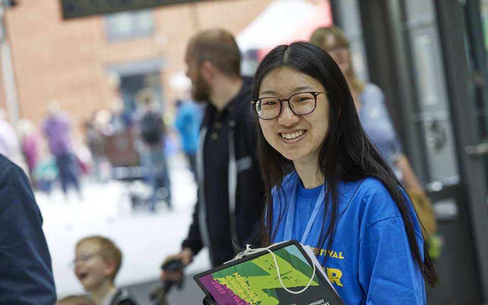 Norfolk & Norwich Festival 2017 volunteer holding a survey clipboard.