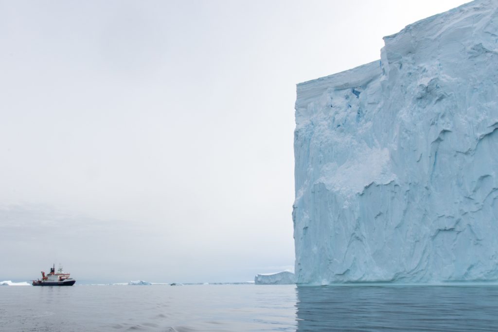 The research vessel Polarstern near an iceberg in Pine Island Bay. (Photo: Thomas Ronge)